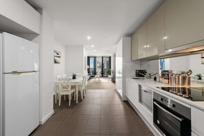 Fridge, microwave, oven, stovetop - City Living North-Facing 2B2B near Marvel Stadium (Melbourne)