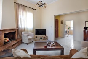 Economy House | Living area | 50-inch Smart TV with cable channels, fireplace - Casa Alta with mountain views (Platanias)