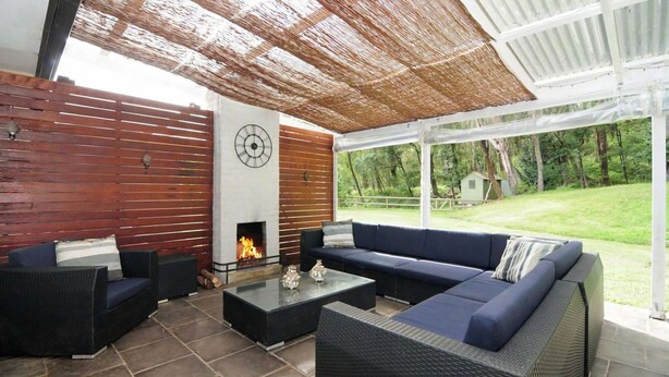 An outdoor patio with a fire pit, a sofa, and a dining table. - Lavender Hill, Kangaroo Valley (Kangaroo Valley)
