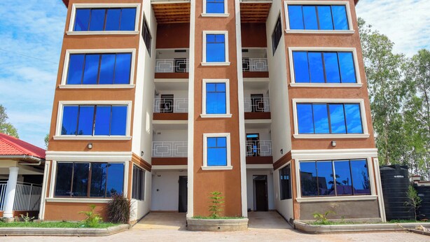 A multi-story residential building with balconies and large windows. - Grand Duke Hotel Limited (Homa Bay)