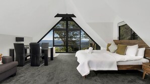 A bedroom with a large bed, a desk, and a chair, with a view of the outdoors. - Valley View Studio, Kangaroo Valley (Beaumont, Kangaroo Valley)