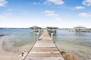 A wooden pier leading to three wooden gazebos over clear water. - Heron Landing 14- Beach access, on Little Lagoon (Gulf Shores)