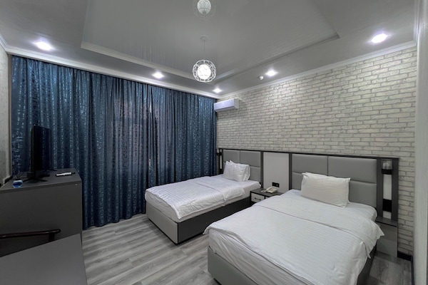 Premium bedding, Tempur-Pedic beds, desk, laptop workspace