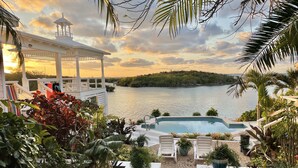 A pool area with a view of a lake and a gazebo. - Saltwater Sanctuary-Secret garden in a tropical paradise (Hope Town)