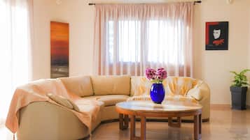 City House | Living area | 55-inch Smart TV with cable channels