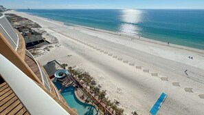 A beach resort with a pool, beach umbrellas, and a clear view of the ocean. - Beachfront 3BR with water slide!  New to the Rental Market!! (Gulf Shores)