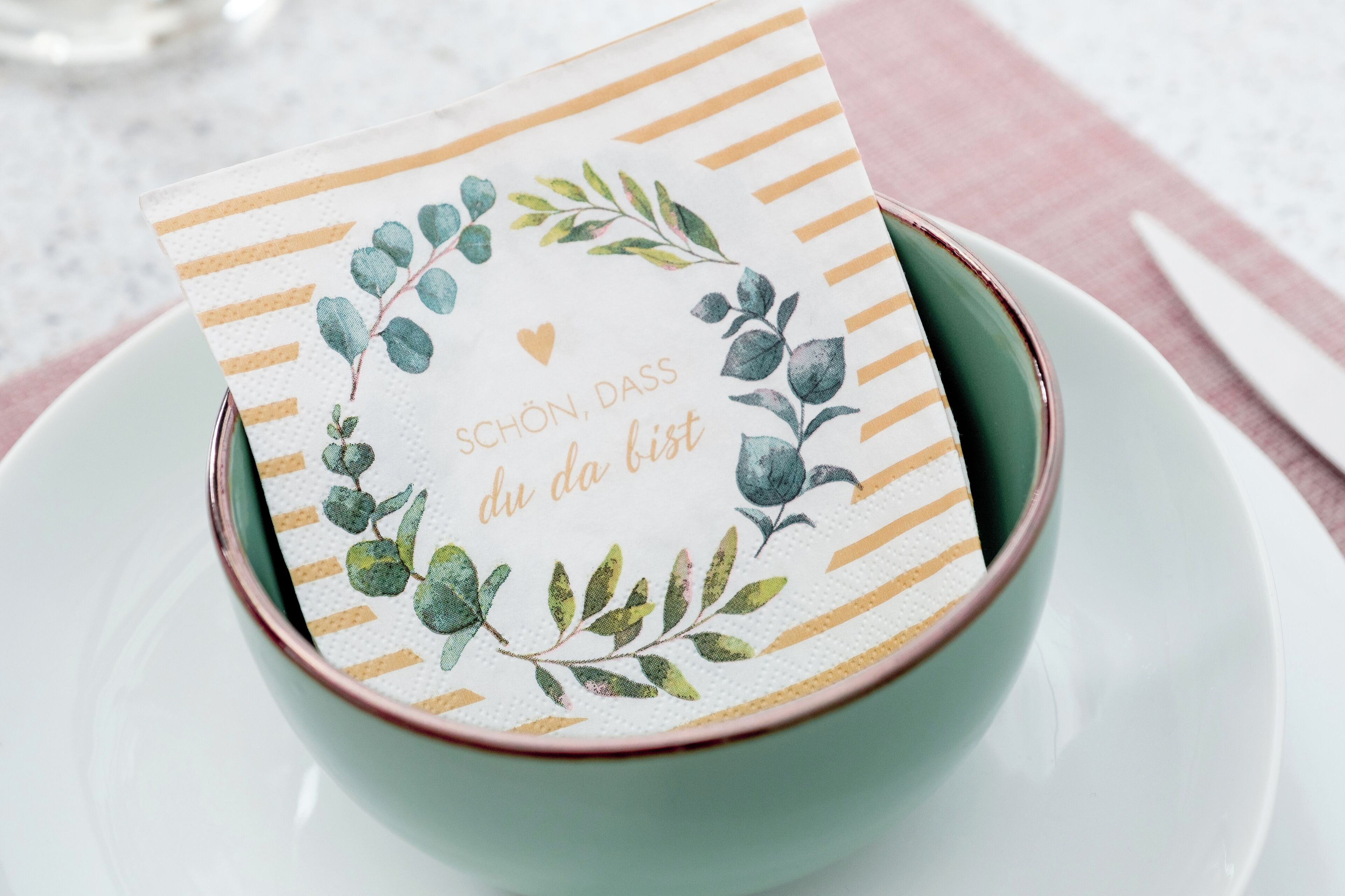 A card with a floral design and text in a bowl.
