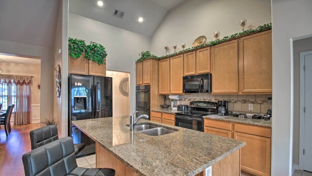 A modern kitchen with granite countertops, stainless steel appliances, and wooden cabinets. - Screened Patio: Rincon Home, 18 Mi to Savannah! (Rincon)