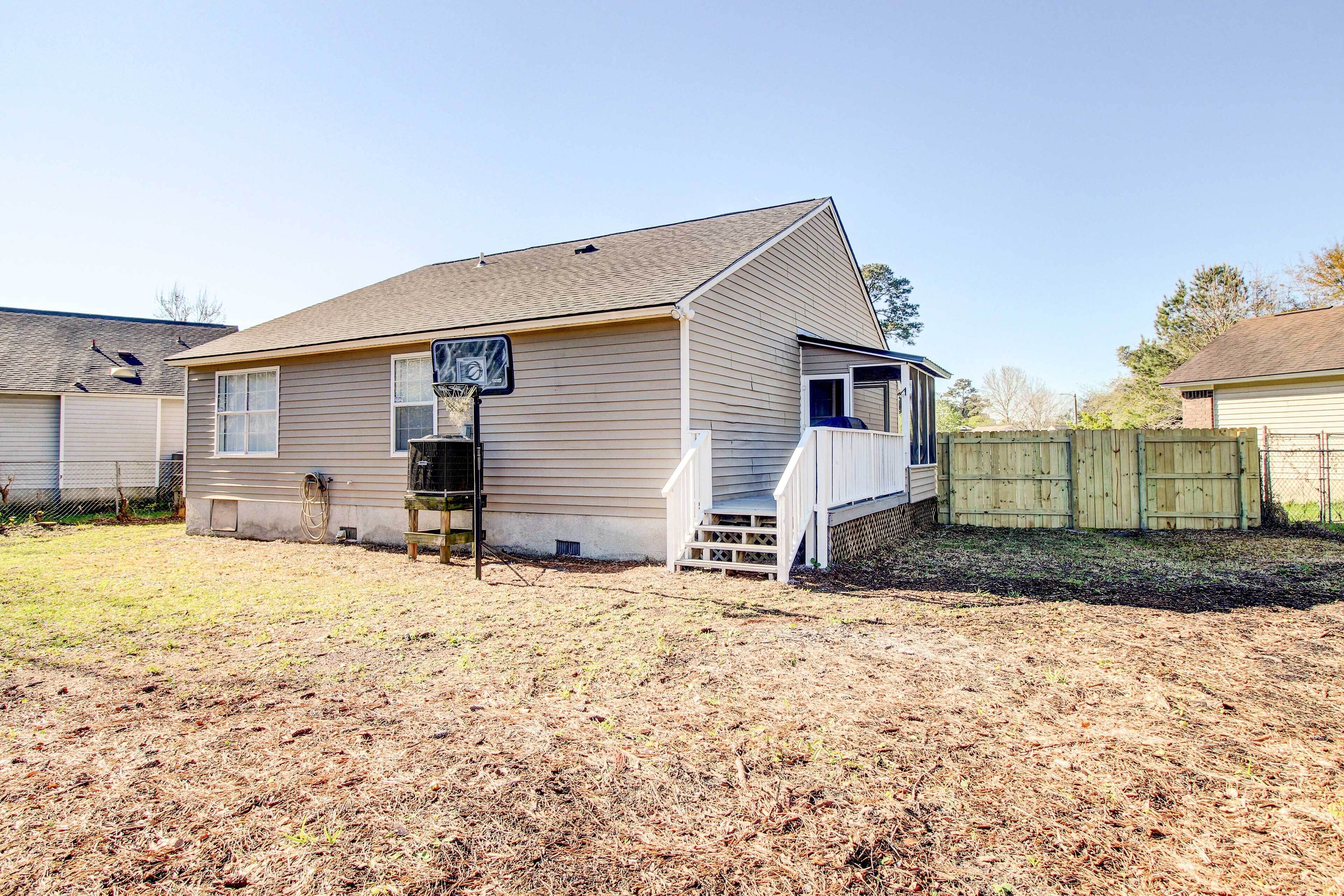 A single-story house with a front porch and a small deck.