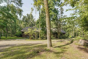 A rustic cabin surrounded by a dense forest. - Clarks Hill Lake Area Home w/ Pool & Dock! (Lincolnton)