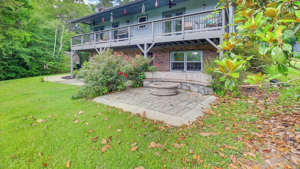 A two-story house with a balcony, surrounded by a well-maintained lawn and trees. - Kingston Home w/ Shared Pool - 23 Mi to Lakepoint! (Kingston)