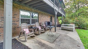 An outdoor patio with a brick wall, a covered seating area with chairs and tables, and a bench. - Kingston Home w/ Shared Pool - 23 Mi to Lakepoint! (Kingston)