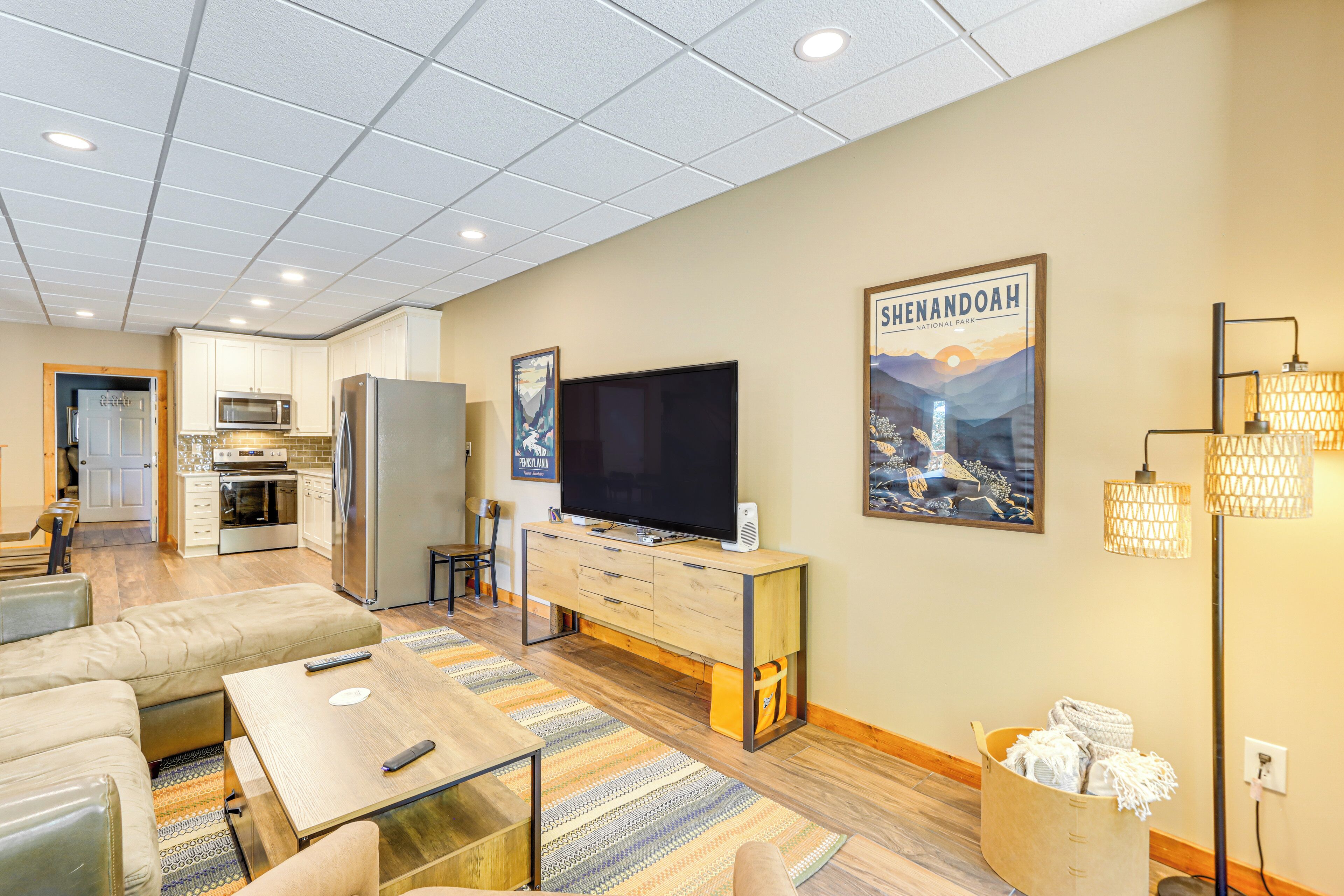 A modern living room with a TV, sofa, and dining area.