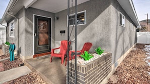 A house with a brick exterior, a front door, and a porch with red chairs. - 0651: Central Salida Home 5 Blocks to Dtwn & River (Salida)