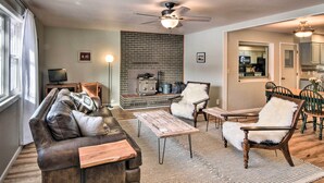 A living room with a leather sofa, wooden coffee table, and a fireplace. - 0651: Central Salida Home 5 Blocks to Dtwn & River (Salida)