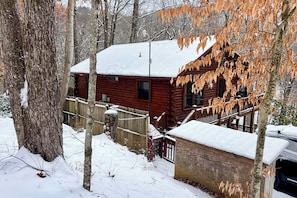 A wooden cabin with a snow-covered roof, surrounded by trees and a wooden fence. - Peaceful Blue Ridge Cabin w/ Decks & Fire Pit (Blue Ridge)