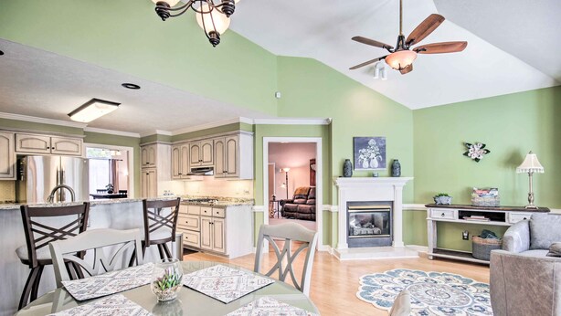 A spacious living area with a dining table, chairs, and a fireplace. - Gorgeous Evans Retreat < 14 Mi to Augusta! (Evans)