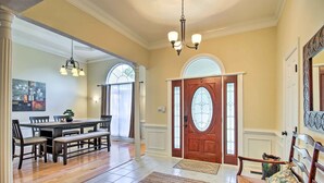A spacious dining area with a wooden table and chairs, a bench, and a chandelier. - Gorgeous Evans Retreat < 14 Mi to Augusta! (Evans)