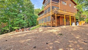 A two-story log cabin with a balcony, surrounded by a forested area. - Serene Blue Ridge Cabin ~ 3 Mi to Downtown! (Blue Ridge)