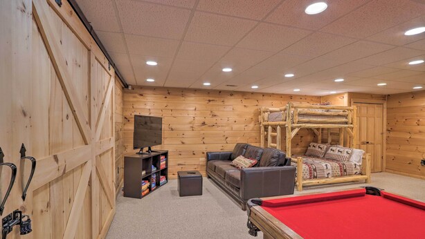 A cozy room with a pool table, a sofa, a bunk bed, and wooden walls. - Serene Blue Ridge Cabin ~ 3 Mi to Downtown! (Blue Ridge)