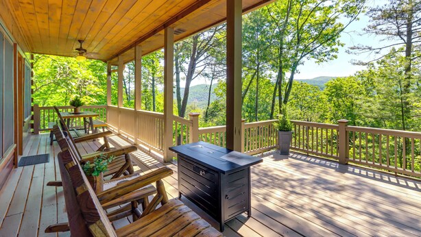 A wooden deck with outdoor seating, a grill, and a view of a forested area. - 2 Queen Suites, Trail Access, Mtn View, Fire Table (Blue Ridge)