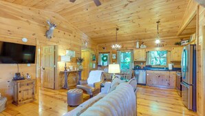 A log cabin interior with a living room, kitchen, and dining area. - 2 Queen Suites, Trail Access, Mtn View, Fire Table (Blue Ridge)