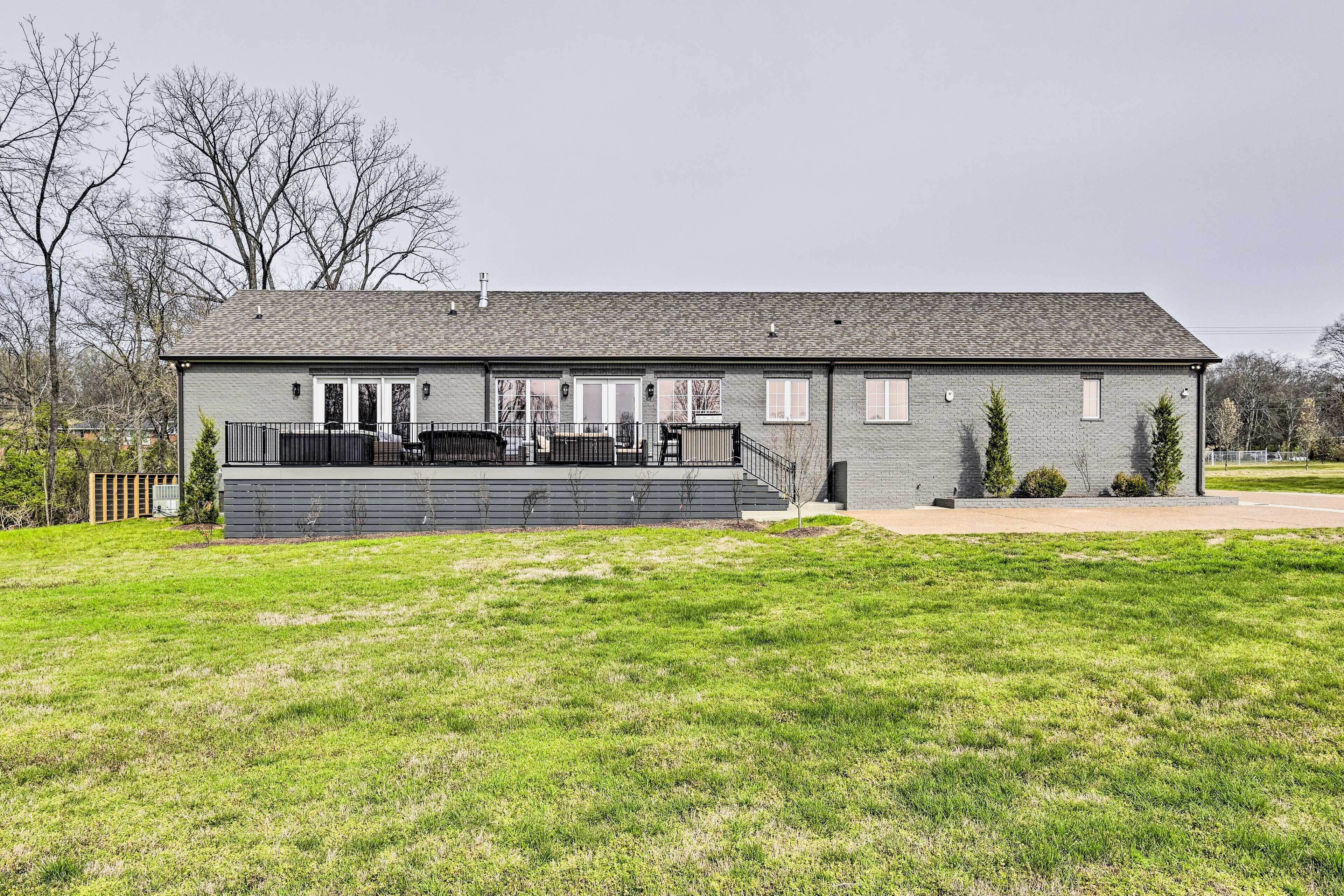 A two-story building with a flat roof, a covered front porch, and a small front yard.