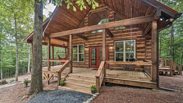 A log cabin with a wooden deck, a red door, and a covered porch. - Peaceful Cabin on 3 Private Acres: Deck & Fire Pit (Morganton)