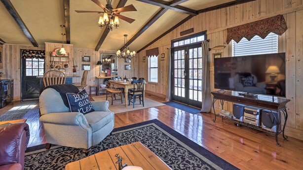 A spacious living room with a fireplace, a dining area, and a kitchen.