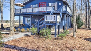 A blue building with a red door, a balcony, and a sign that reads "Chalet".
