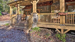 A rustic wooden cabin with a stone foundation, a wooden porch, and a sign that reads "Welcome." - Tubes & Kayaks: 5-acre North Georgia Mtn Retreat (Sautee Nacoochee)