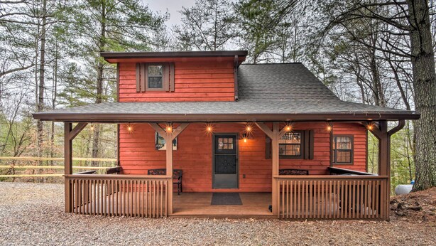 A two-story wooden cabin with a porch, a front door, and a small window above the door. - Modern Cabin w/ Deck in the Blue Ridge Mountains! (Blairsville)