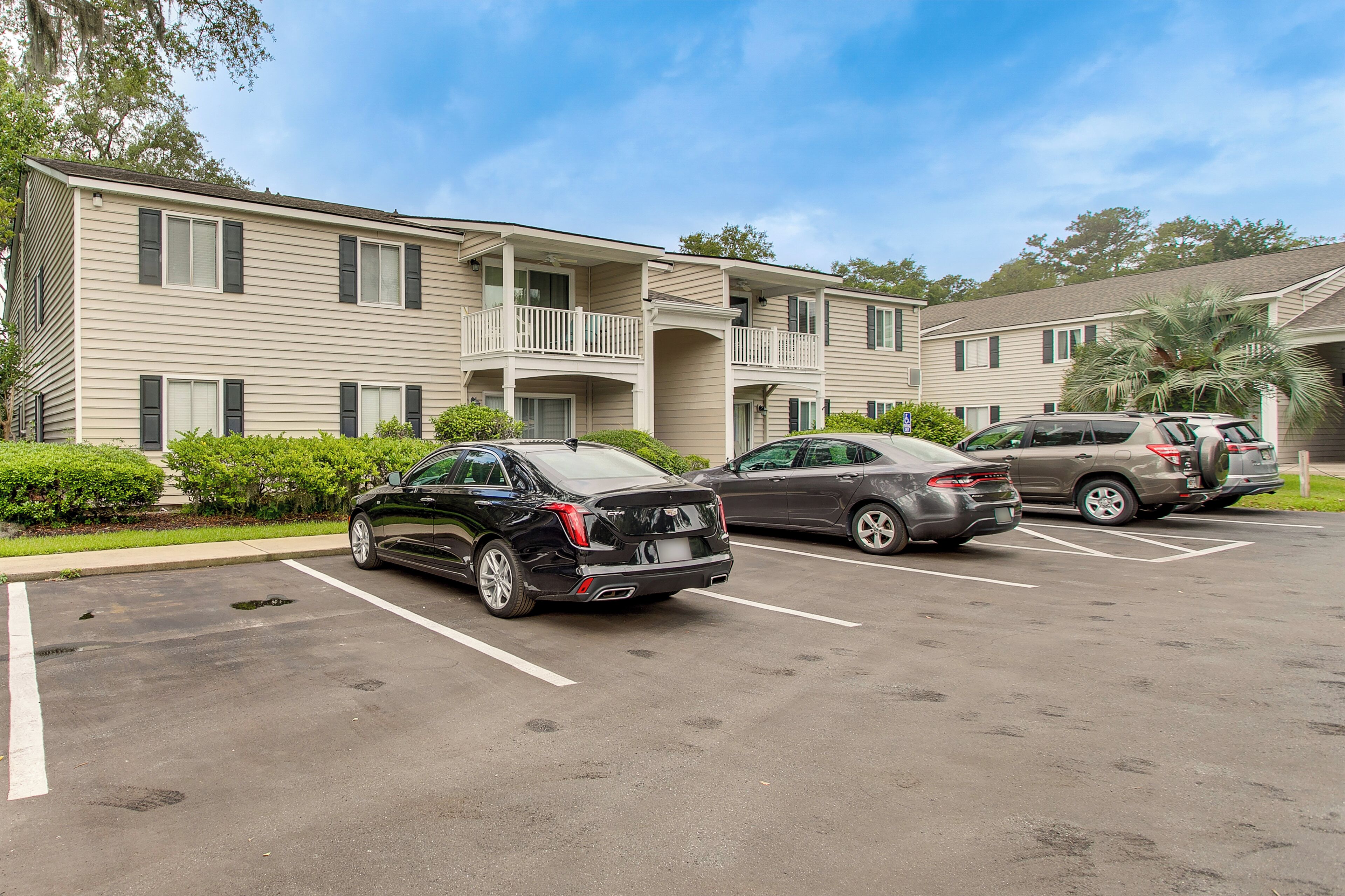 A multi-story motel with a parking lot.