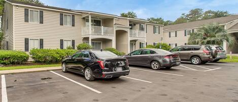 A multi-story motel with a parking lot.