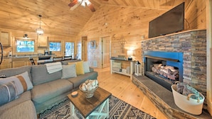 A cozy cabin interior with a living room, fireplace, and kitchen area. - Blue Ridge Hideaway w/ Fire Pit & Mtn Views! (Blue Ridge)