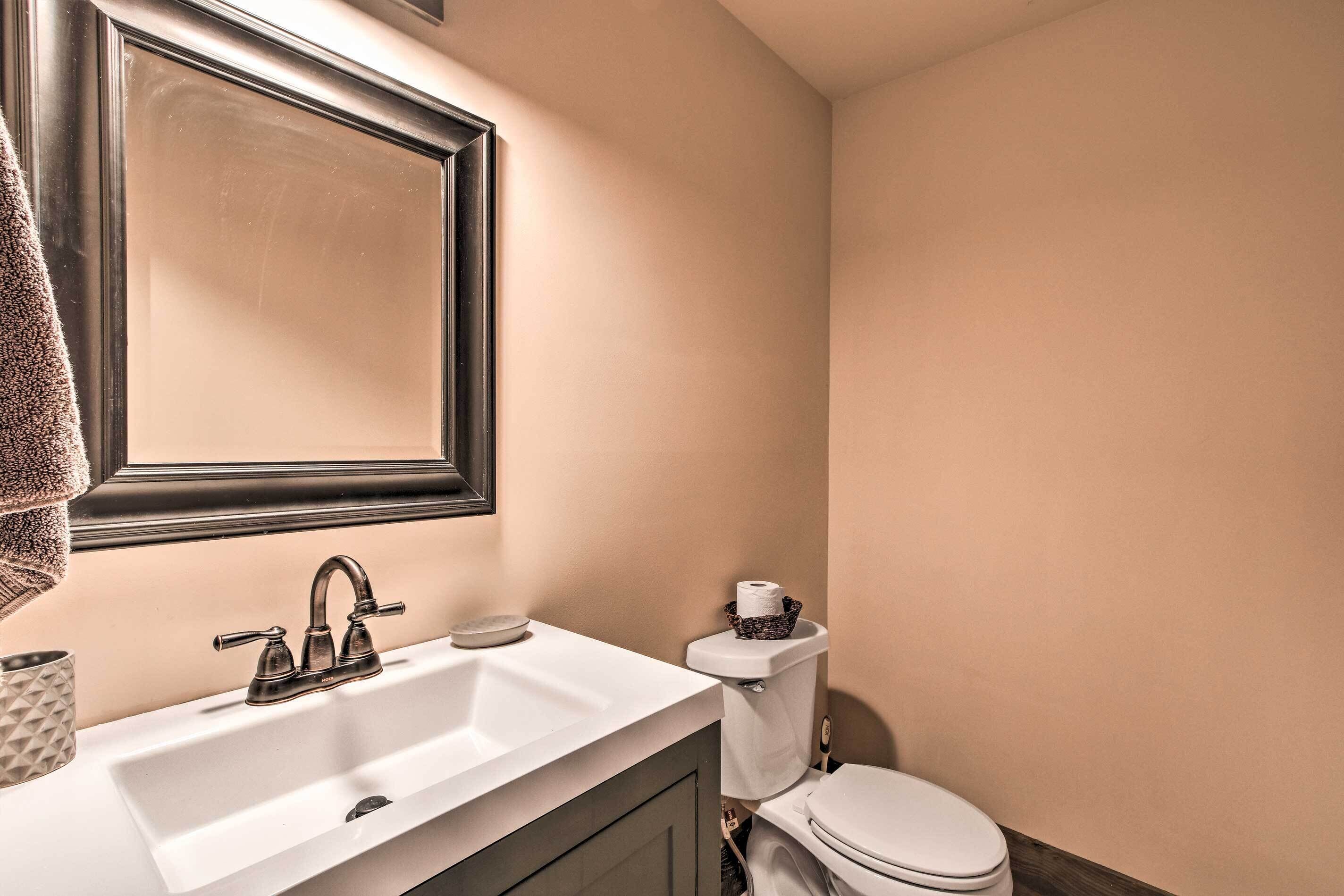 Ein Badezimmer mit Waschbecken, Spiegel und Toilette.