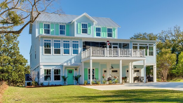 A two-story house with a balcony, a covered front porch, and a driveway. - Harbor Oaks Haven: Walk to Front Beach & Downtown! (Ocean Springs)