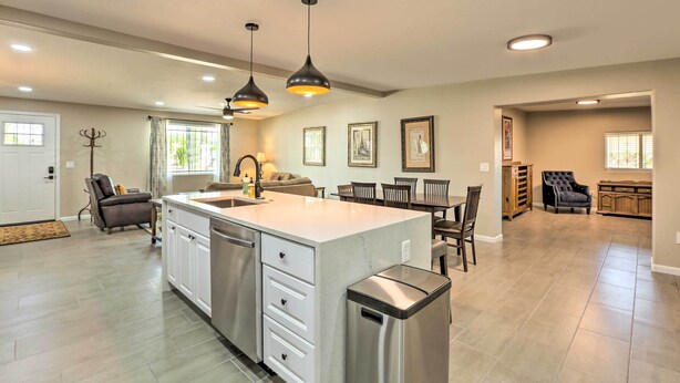 A spacious kitchen with a large island, pendant lighting, and a dining area with a table and chairs. - Tucson Getaway w/ Private Pool & Gas Grill! (Tucson)