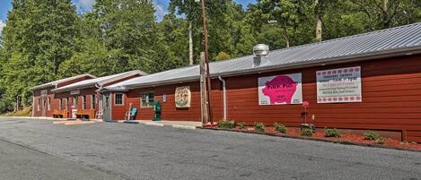 A row of red-roofed buildings with signs advertising a restaurant.