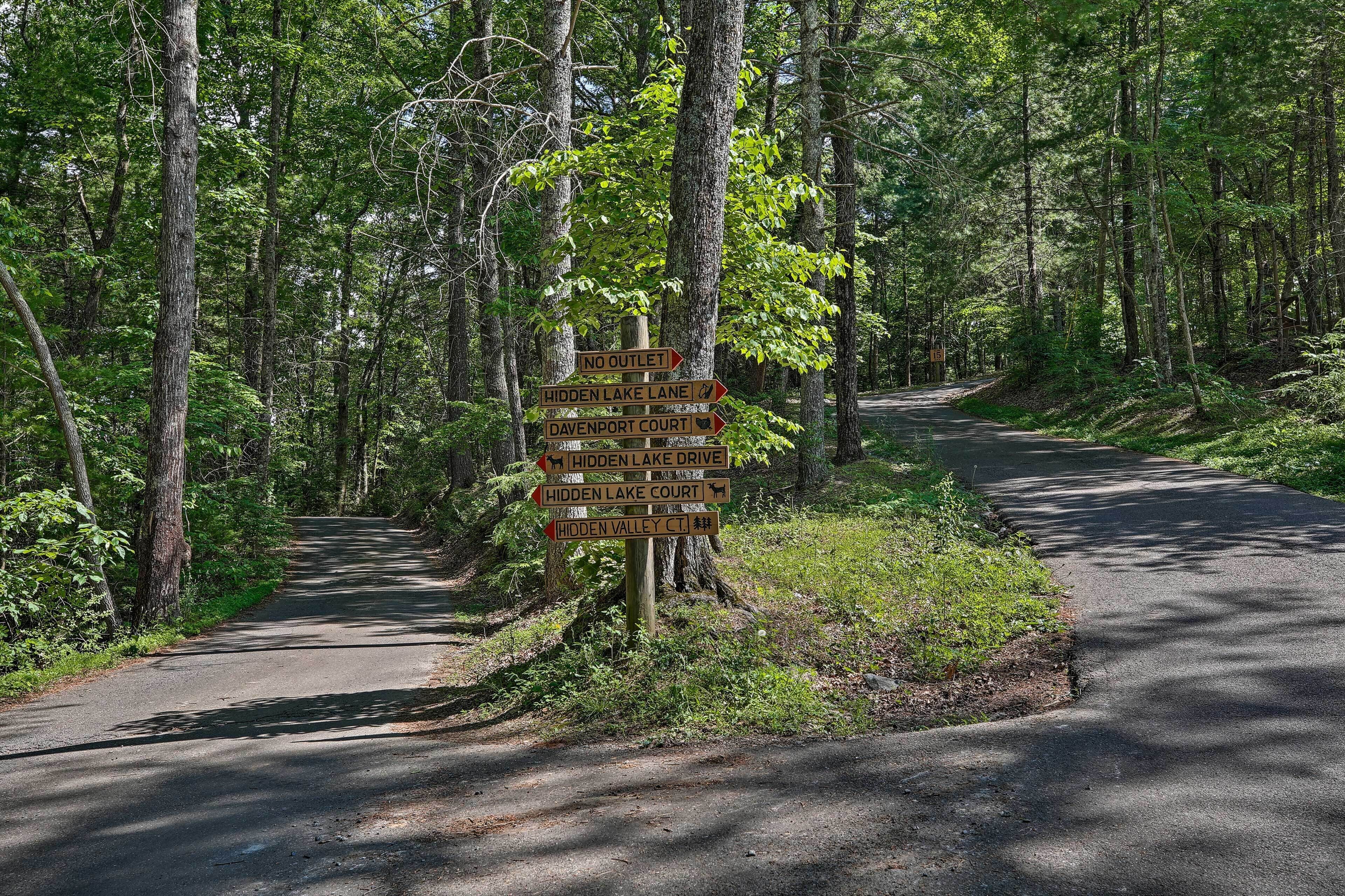 A directional signpost in a forested area with multiple paths indicated.