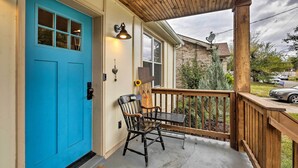 A blue door, a wooden porch, a chair, and a table. - Nashville Home w/ Fire Pit & Yard, 3 Mi to Dwtn (Nashville)