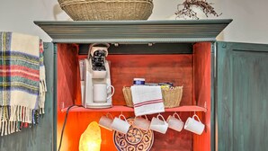 A kitchen area with a coffee machine, a salt lamp, and a decorative bowl. - Cozy & Quiet Studio w/ Porch, Near Scenic Railway! (Blue Ridge)