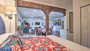 A bedroom with a large bed, a wooden ceiling, and a view into the dining area. - Cozy & Quiet Studio w/ Porch, Near Scenic Railway! (Blue Ridge)