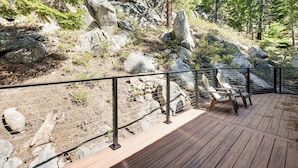 A wooden deck with chairs, surrounded by a metal fence, overlooking a rocky terrain with trees. - 4 Mi to Beach: Lake Tahoe Mountain Retreat! (Stateline)