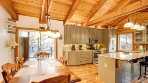A spacious kitchen with wooden beams, a large island, and modern appliances. - 4 Mi to Beach: Lake Tahoe Mountain Retreat! (Stateline)