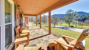 A covered patio with stone flooring, wooden furniture, and a view of a mountainous landscape. - Sky Valley Retreat w/ Resort Amenities & Views! (Dillard)