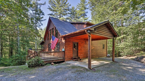 A log cabin with a porch, an American flag, and a gravel driveway. - Cozy Blue Ridge Cabin w/ Sauna & Trail Access! (Blue Ridge)