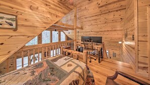A cabin with a loft bedroom, a desk, and a chair. - Cozy Blue Ridge Cabin w/ Sauna & Trail Access! (Blue Ridge)