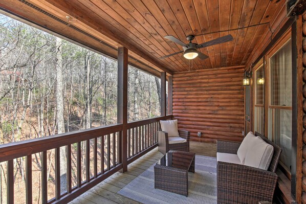 A wooden deck with wicker furniture, a ceiling fan, and a view of the forest. - Outdoor Lover's Haven in the Blue Ridge Mtns! (Blue Ridge)