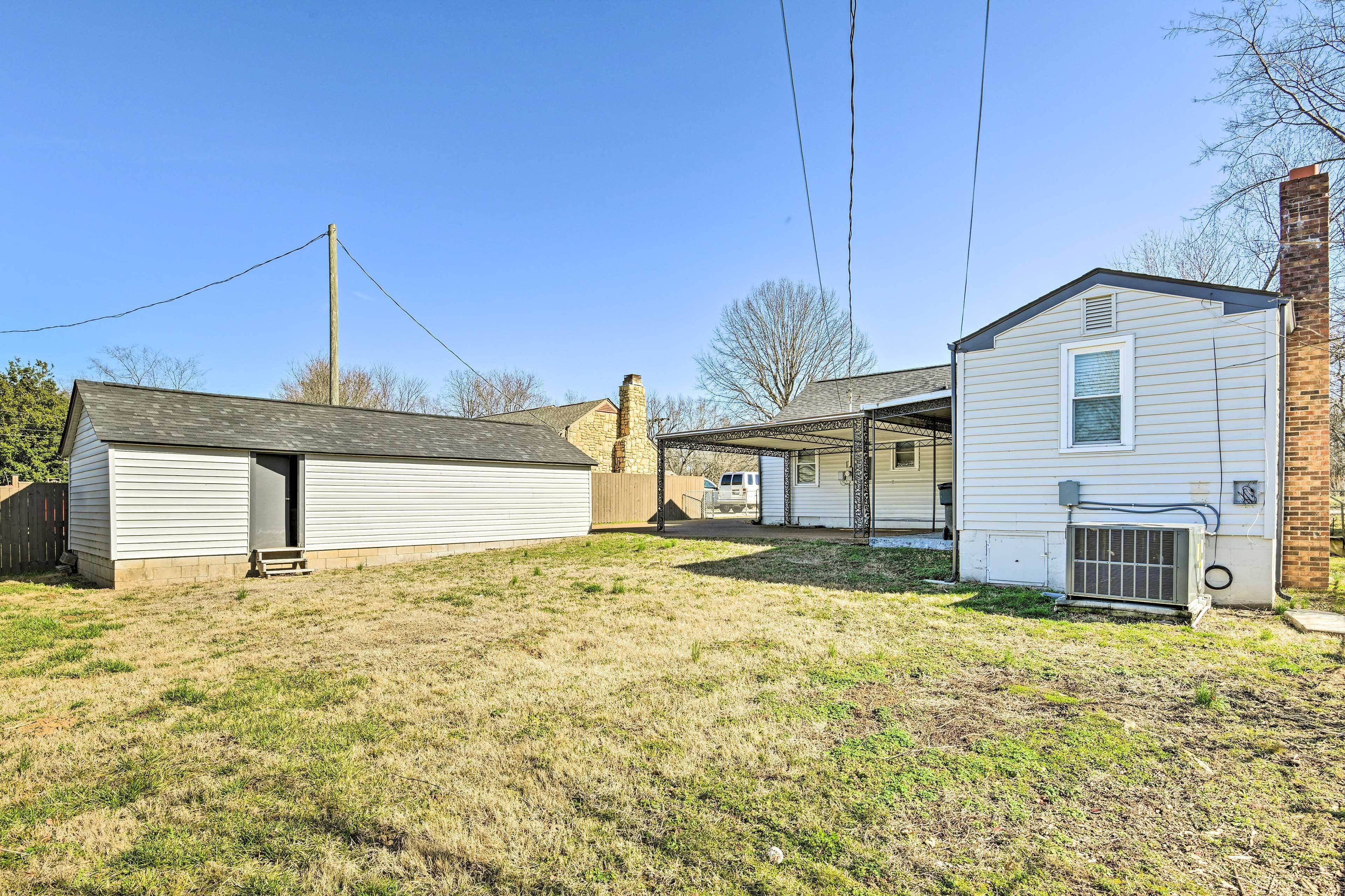 A residential area with a detached garage, a covered porch, and a brick chimney.